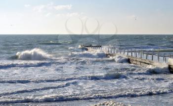 Sea wave splashing against a pier in Odessa. Black Sea.