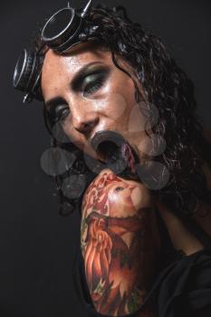 Portrait of Brutal Steampunk Girl over Black Background