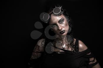 Portrait of Brutal Steampunk Girl over Black Background