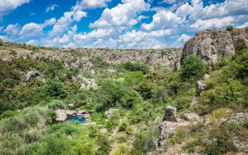 Panoramic view of deep granite Aktovo canyon with river and cloudy sky, One of the natural wonders of Ukraine.