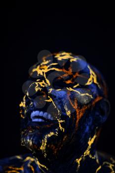 Conceptual Portrait of a man painted in fluorescent UV colors and looks like Neon lava