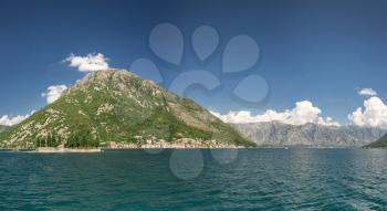 Panoramic view from the sea to the Kamenari-Lepetane Ferry crossing in the Bay of Kotor, Montenegro, in a sunny summer day.