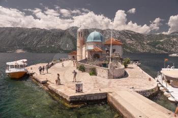 Perast, Montenegro - 07.11.2018.  Our Lady of the Rocks church on an Island in the Bay of Kotor, Montenegro,  in a sunny summer day