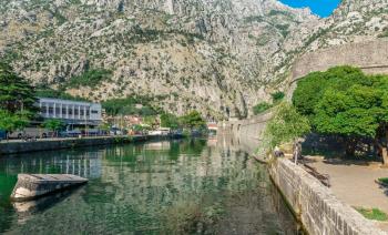 Kotor, Montenegro - 07.11.2018. Massive walls of the fortification Bastion Riva by the river Shkurda in Kotor Old Town in a sunny summer day