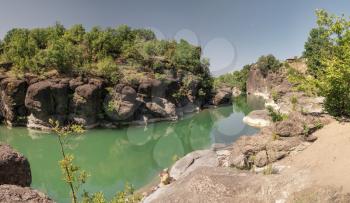 Venetikos river with green water and  beautiful rock formations near Meteora in Greece