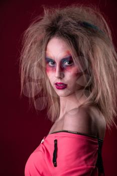 Emotional Portrait of a Attractive young girl with carnival colorful makeup and disheveled hair