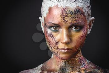 Portrait of Beautiful Young Woman with creative fantasy bird makeup