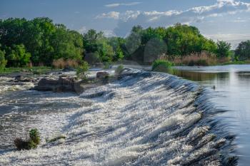 Power station dam on the Southern Bug River near the village of Migiya, Ukraine, on a sunny summer day