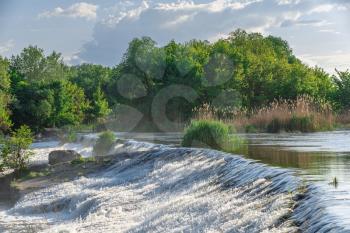 Power station dam on the Southern Bug River near the village of Migiya, Ukraine, on a sunny summer day