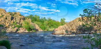 The rocky banks of the Southern Bug River near the village of Migiya in Ukraine on a sunny summer day