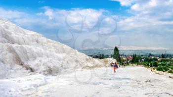 Pamukkale, Turkey – 07.15.2019. White mountain and green lake in Pamukkale. Panoramic view from above on a summer morning.