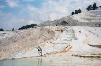 Pamukkale, Turkey – 07.15.2019. Mineral forests, petrified waterfalls and terraced basins in Pamukkale, Turkey, on a summer morning.