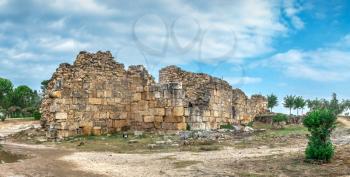Walls of the Hierapolis ancient city in Pamukkale, Turkey, on top of the white Pamukkale mountain on a summer morning.