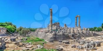 The southern flank of the temple of Apollo with the stadium at Didyma, Turkey, on a sunny summer day