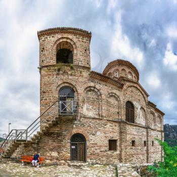 Asenovgrad, Bulgaria 24.07.2019. Church of the holy mother of God in the Asens Fortress surrounded Bulgarian Rhodope mountains on a cloudy summer day