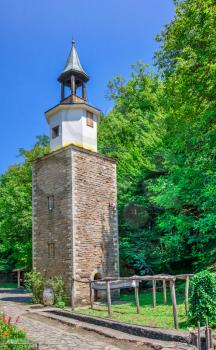 Clock tower in the Etar Architectural Ethnographic Complex in Bulgaria on a sunny summer day. Big size panoramic photo.