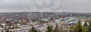 Pochaev, Ukraine 01.04.2020.  Panoramic top view of the Pochaev village from the terrace of Holy Dormition Lavra in Ukraine, on a gloomy winter morning
