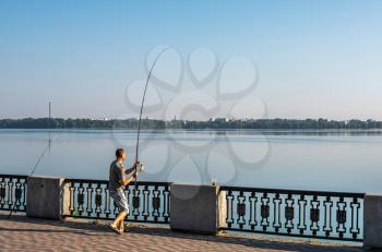 Dnipro, Ukraine 07.18.2020. Fishermans on the Dnipro embankment on a sunny summer morning