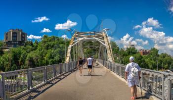 Dnipro, Ukraine 07.18.2020. Pedestrian bridge to the monastery island across the Dnieper river in Dnipro, Ukraine, on a sunny summer day