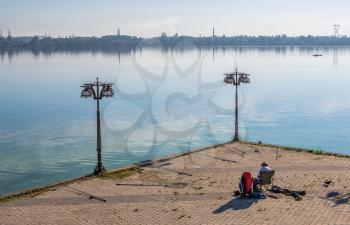 Dnipro, Ukraine 07.18.2020. Fishermans on the Dnipro embankment on a sunny summer morning