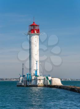 Odessa, Ukraine 06.06.2020. Lighthouse at the entrance to the harbor of Odessa seaport, on a sunny summer day