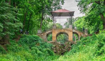 Bila Tserkva, Ukraine 06.20.2020. Chinese bridge in the Alexandria park, one of the most beautiful and famous arboretums in Ukraine, on a cloudy summer day.