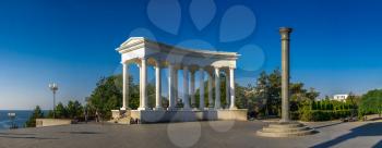 Chernomorsk, Ukraine 08.22.2020. Colonnade and Obelisk of Glory in Chernomorsk city on a sunny summer morning