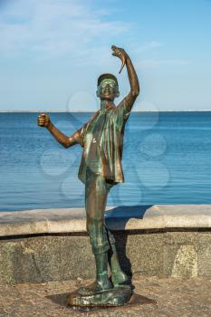Berdyansk, Ukraine 07.23.2020. Monument to the fisherman on the embankment of Berdyansk, Ukraine, on a sunny summer morning
