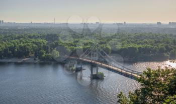 Kyiv, Ukraine 07.11.2020. Top view of the Pedestrian bridge across the Dnieper river on a sunny summer morning