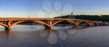 Kyiv, Ukraine 07.11.2020. Kyiv Metro bridge across the Dnieper river on a sunny summer evening.