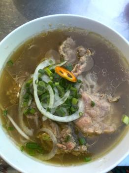 Big closup bowl of Vietnamese beef noodle soup, Pho Bo. Mobile Photo
