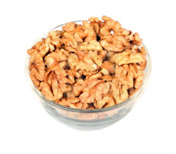 Walnuts in glass plate isolated on white background