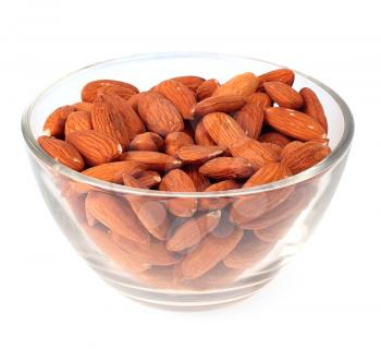Almonds in glass plate isolated on white background