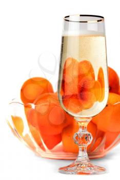Snifter of champagne with tangerines isolated on white background