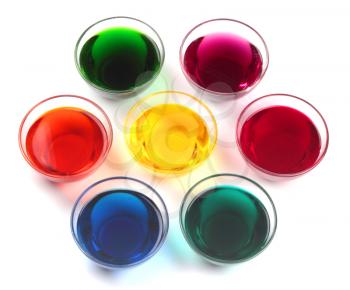 Seven glass caps with dyes for easter eggs isolated on white background