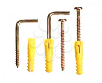 Screws and yellow plastic dowels isolated on white background