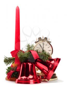 New Year decoration with red candle, two red bells and golden clock