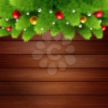 Wooden background with branches of Christmas tree and baubles