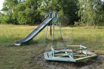 Children playground. Swings and a slide to slide.
