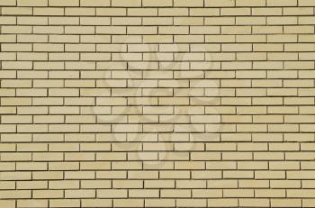 Background of yellow brick. Wall paved with yellow brick.
