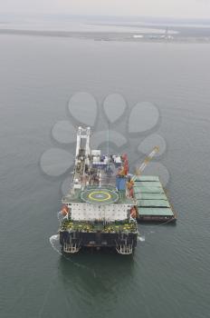 The cargo ship with the crane, the top view. Pipelaying barge.