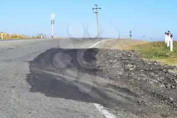 Repair of an asphalt road surfacing. A patch on asphalt.