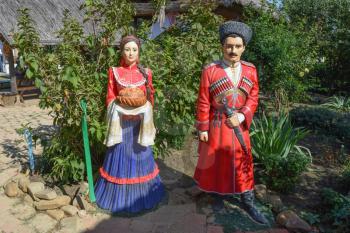 Statue of Cossack and Cossack-girl. The tradition to welcome guests with bread and salt.