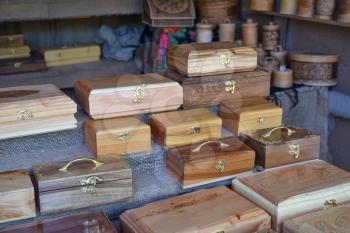 Wooden boxes on the counter. Wooden souvenirs in the form of boxes with locks.