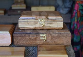 Wooden boxes on the counter. Wooden souvenirs in the form of boxes with locks.