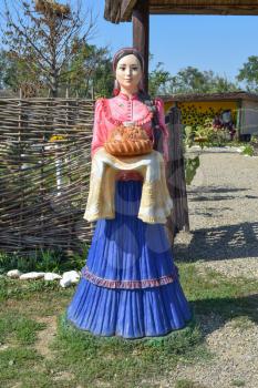 Dummy of the gypsum in the form of a girl meets guests. The tradition to welcome guests with bread and salt.
