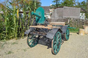 Green fake ancient gun on a cart. Decorative objects.