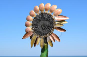 Statue of copper flower sunflower. Decorative elements.