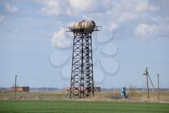 Rusty water tower. An old rustic communal communication.