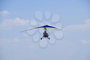 Russia, Veselovka - September 6, 2016: Trike, flying in the sky with two people. Extreme Entertainment travelers.